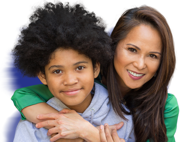 Mother smiles while embracing preteen son.